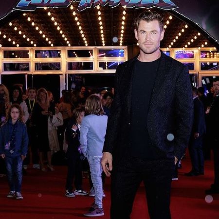 Chris Hemsworth wearing a black suit